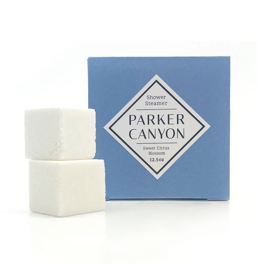 Two white shower steamers with Sweet Citrus Blossom packaging on a white background