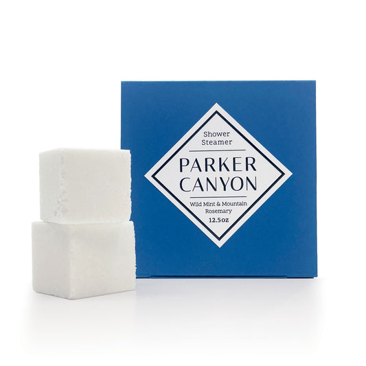 Wild Mint & Mountain Rosemary shower steamers with a primary packaging on a white background