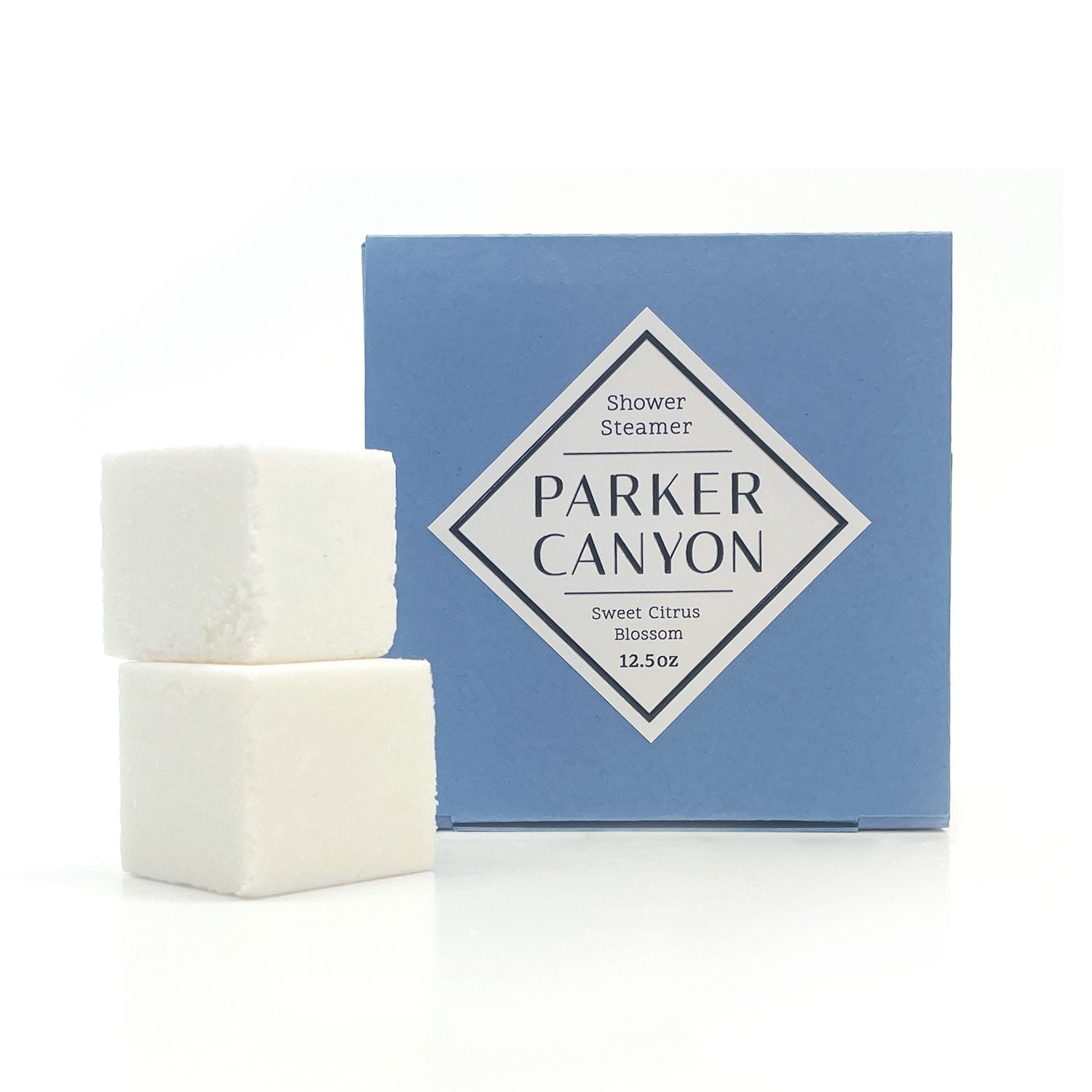 Two white shower steamers with Sweet Citrus Blossom packaging on a white background